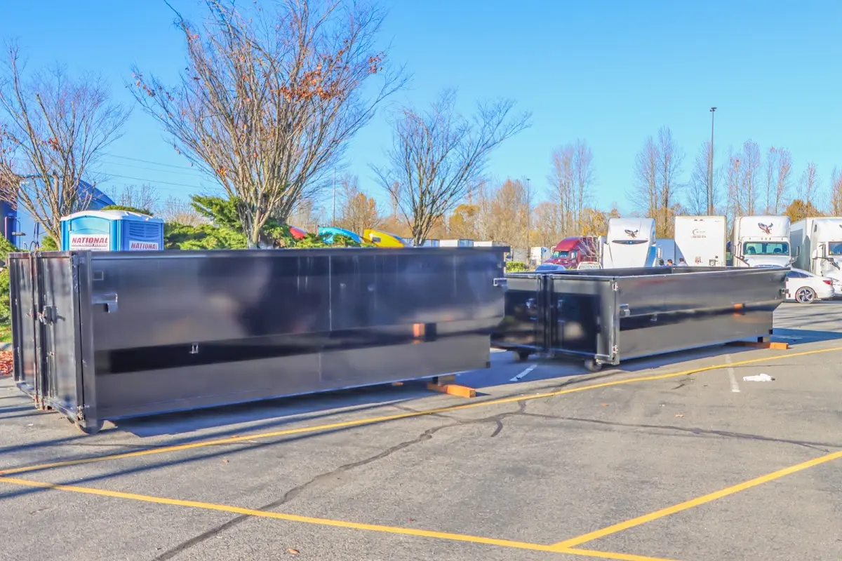 Professional dumpster rental service with roll-off container on residential driveway in Asheboro